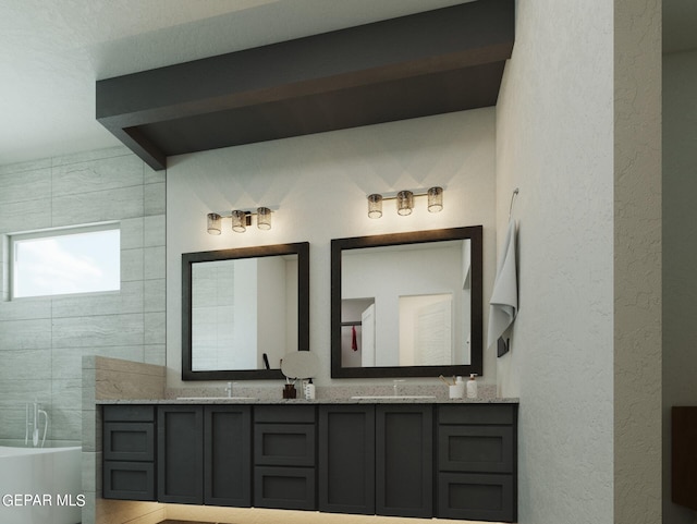 bathroom featuring vanity and a tub to relax in