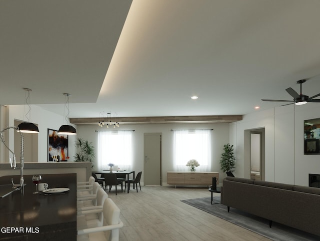 living room with ceiling fan and light hardwood / wood-style flooring