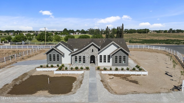 view of front of house with a rural view