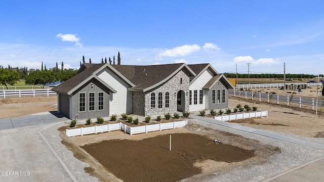 view of front of property featuring a rural view