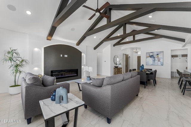 living room featuring vaulted ceiling with beams and ceiling fan with notable chandelier