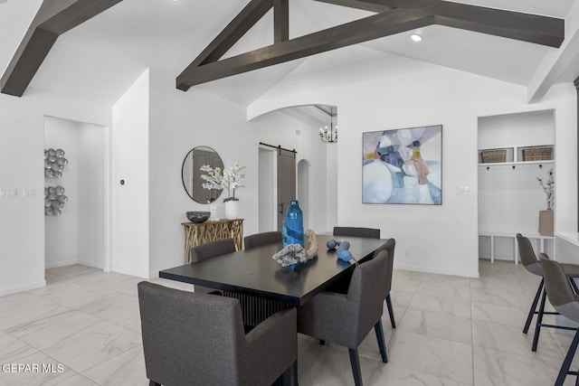 dining area featuring a barn door, lofted ceiling with beams, and a notable chandelier