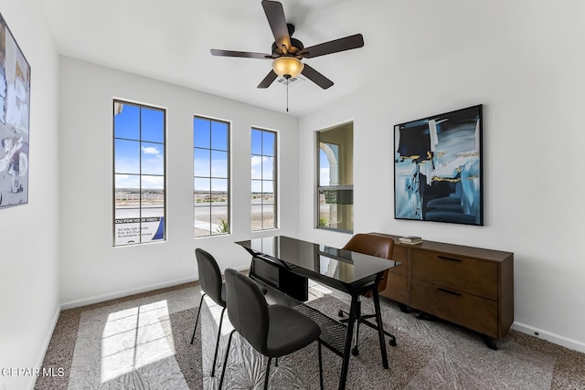 carpeted dining area featuring ceiling fan