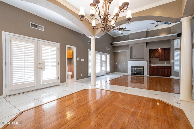 18 Via Placita, El Paso, TX 79927 - unfurnished living room with ornate columns, ceiling fan, tile patterned floors, ornamental molding, and baseboards