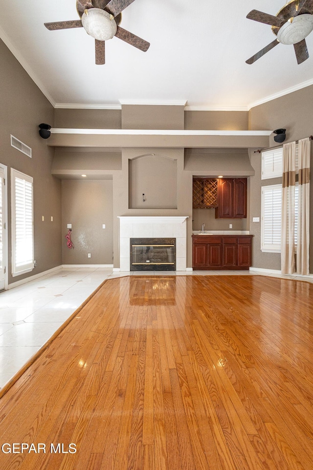 18 Via Placita, El Paso, TX 79927 - unfurnished living room with a ceiling fan, crown molding, baseboards, and a fireplace
