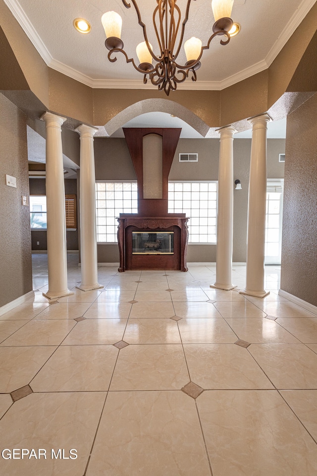 interior space featuring an inviting chandelier, a wealth of natural light, ornamental molding, and light tile patterned flooring