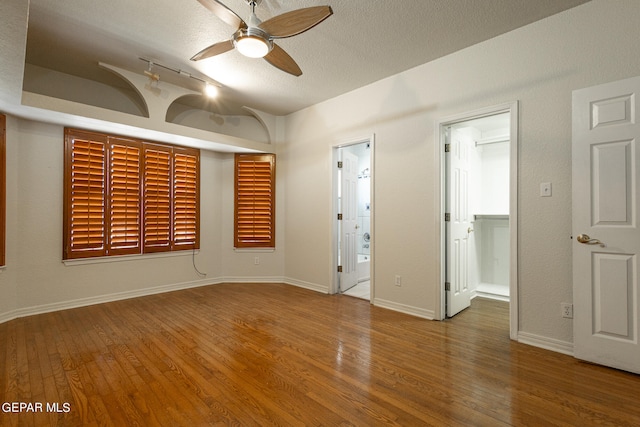 interior space featuring ceiling fan, a textured ceiling, and hardwood / wood-style flooring