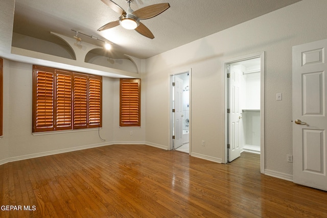 18 Via Placita, El Paso, TX 79927 - empty room featuring a ceiling fan, wood finished floors, a textured ceiling, and baseboards