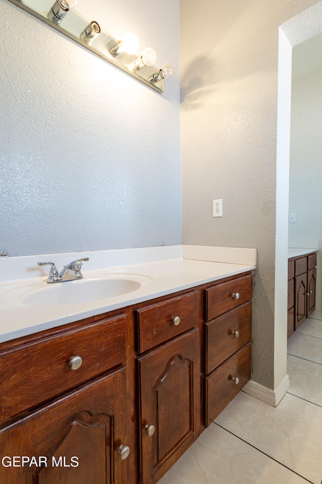 bathroom featuring tile patterned flooring and vanity