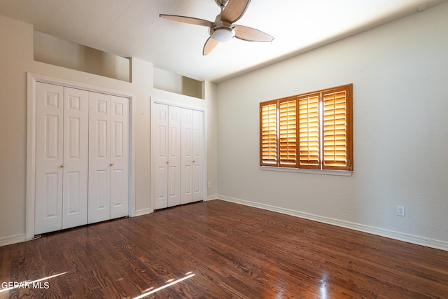 18 Via Placita, El Paso, TX 79927 - unfurnished bedroom with two closets, wood finished floors, baseboards, and a ceiling fan