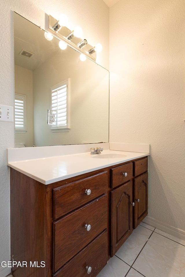18 Via Placita, El Paso, TX 79927 - bathroom featuring vanity, a textured wall, and baseboards