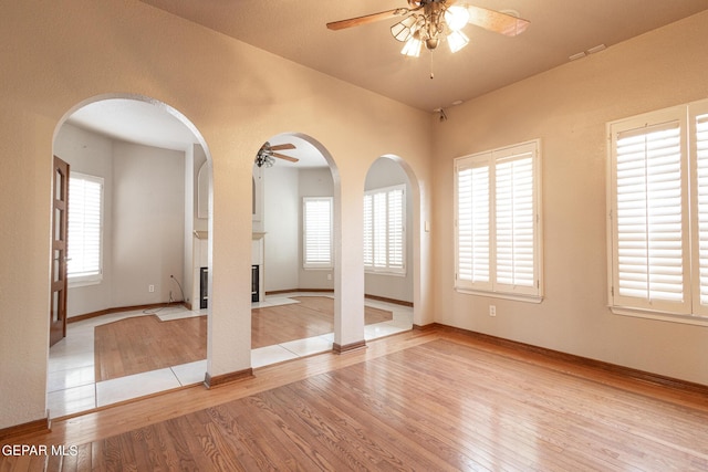 18 Via Placita, El Paso, TX 79927 - empty room featuring a ceiling fan, wood finished floors, and arched walkways