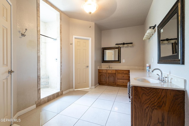 18 Via Placita, El Paso, TX 79927 - bathroom with a walk in shower, tile patterned flooring, two vanities, and baseboards
