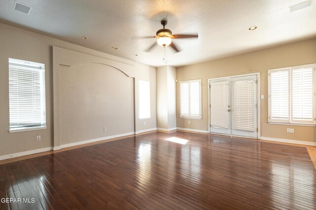 18 Via Placita, El Paso, TX 79927 - unfurnished room with a ceiling fan, healthy amount of natural light, wood-type flooring, baseboards, and a textured ceiling