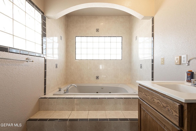 18 Via Placita, El Paso, TX 79927 - full bathroom with a textured wall, a whirlpool tub, and vanity