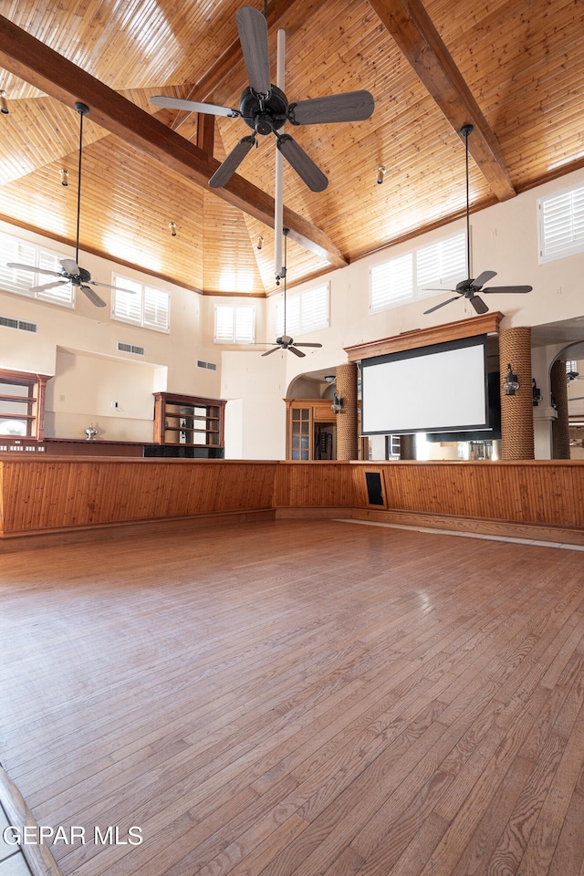 unfurnished room with hardwood / wood-style floors, high vaulted ceiling, beam ceiling, and wood ceiling