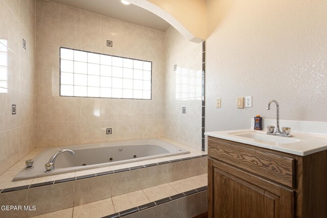 18 Via Placita, El Paso, TX 79927 - bathroom featuring a jetted tub, vanity, and a textured wall