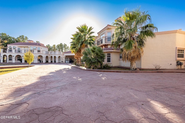 18 Via Placita, El Paso, TX 79927 - mediterranean / spanish-style home with curved driveway, a tile roof, and stucco siding
