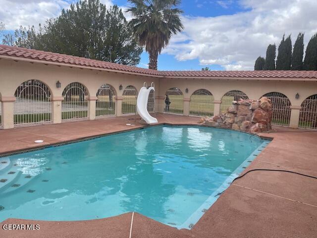 view of swimming pool featuring a water slide