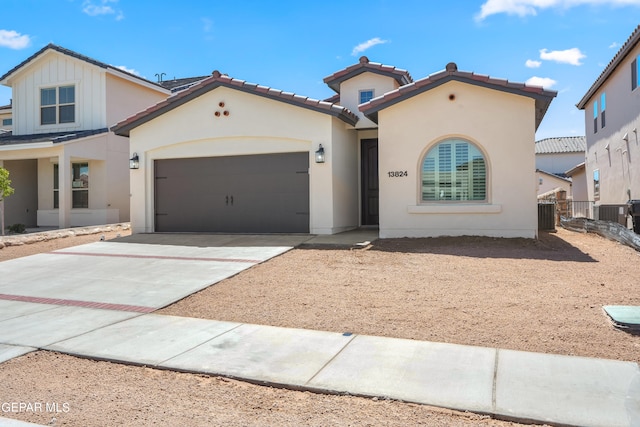 view of front of property with central AC unit and a garage