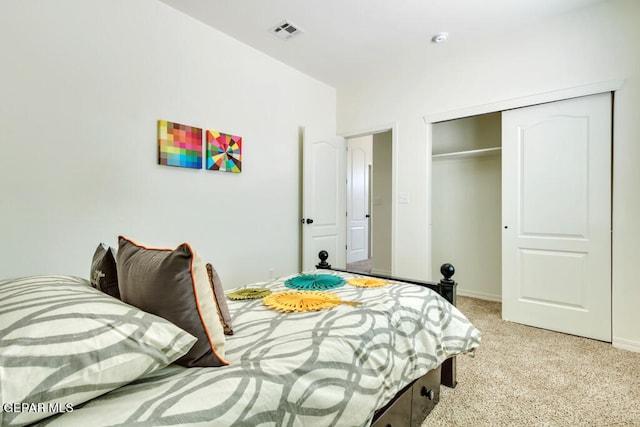 bedroom featuring light colored carpet and a closet