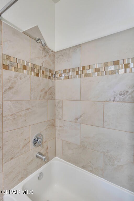 interior details featuring tiled shower / bath