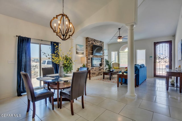 dining area featuring a wealth of natural light, light tile floors, and decorative columns