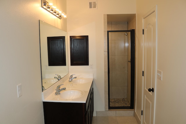 bathroom featuring an enclosed shower, tile floors, and double sink vanity