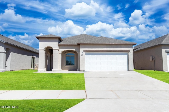 view of front of property with a garage and a front lawn