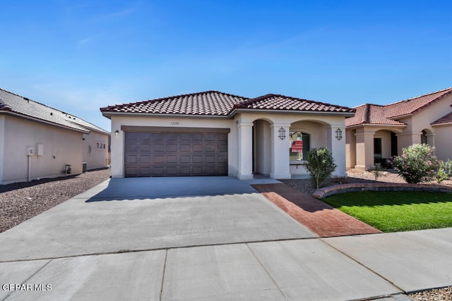 mediterranean / spanish house featuring a garage