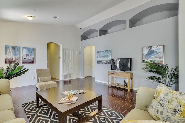 living room with high vaulted ceiling and dark hardwood / wood-style floors