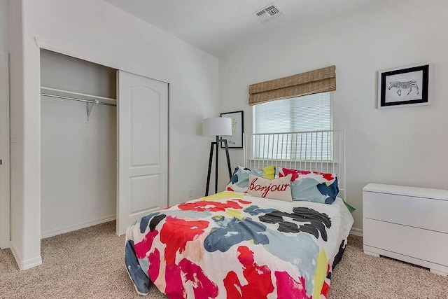 carpeted bedroom with a closet