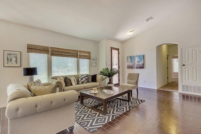 living room featuring dark hardwood / wood-style floors and vaulted ceiling