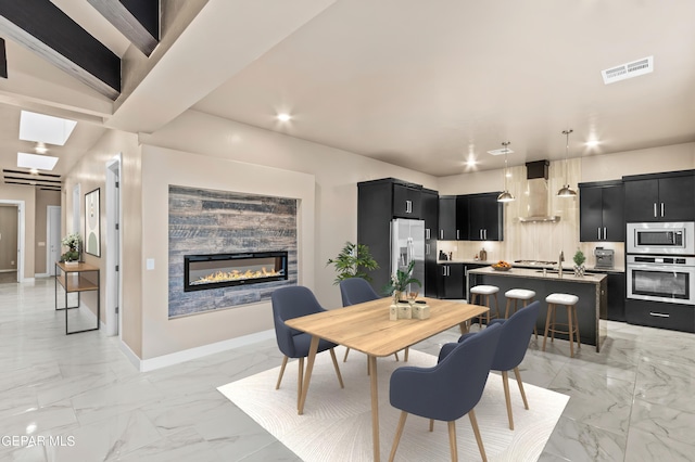 dining room with a skylight