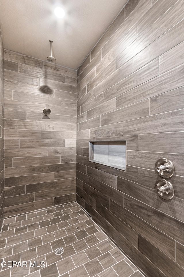 bathroom with a tile shower