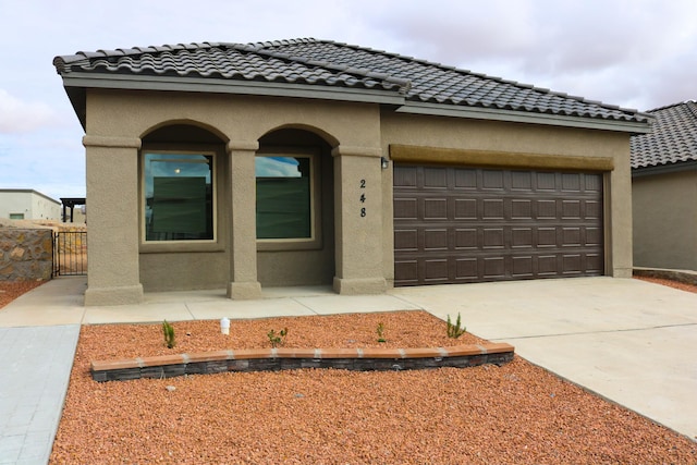 mediterranean / spanish home featuring a garage