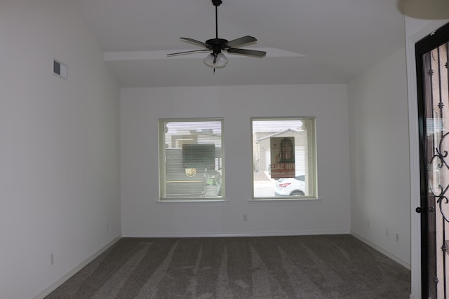 empty room with dark colored carpet and ceiling fan