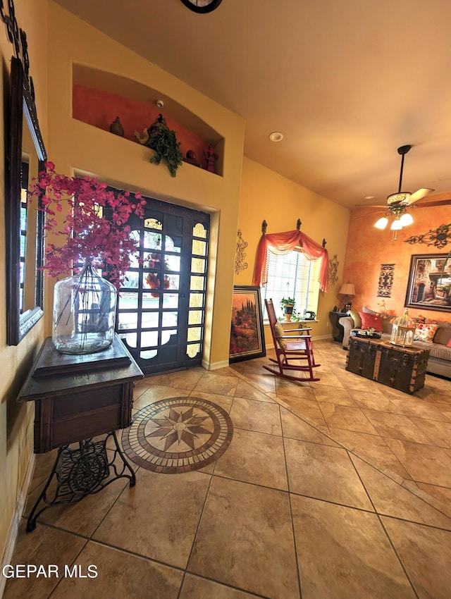 tiled foyer entrance with ceiling fan