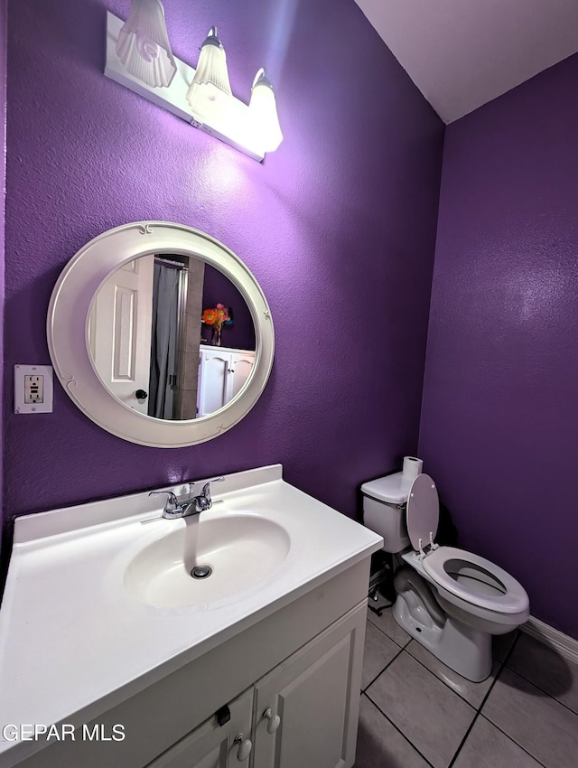 bathroom featuring tile patterned floors, toilet, and vanity