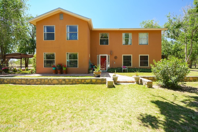 view of front of property with a patio and a front yard