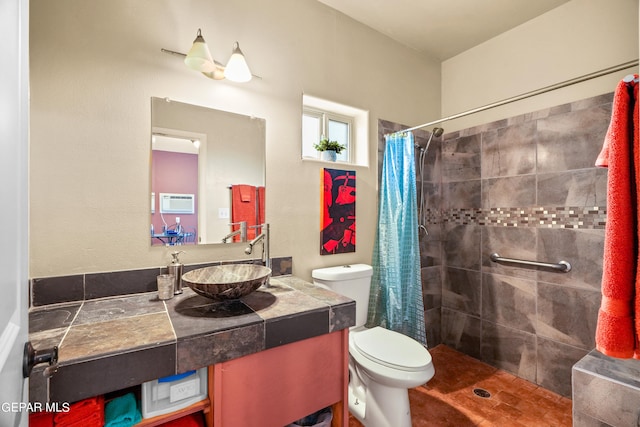 bathroom with walk in shower, vanity, and toilet