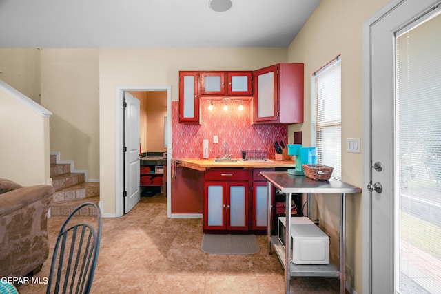 kitchen with backsplash and light tile floors