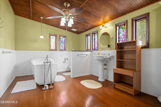 bathroom featuring a wealth of natural light, vaulted ceiling, wood-type flooring, and wooden ceiling