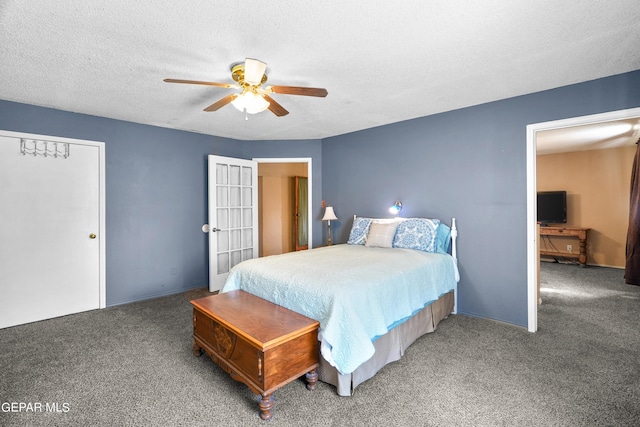 carpeted bedroom with a closet, a textured ceiling, and ceiling fan