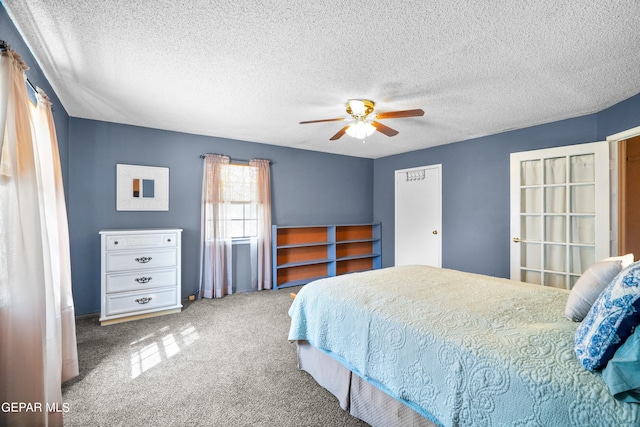 carpeted bedroom with ceiling fan and a textured ceiling