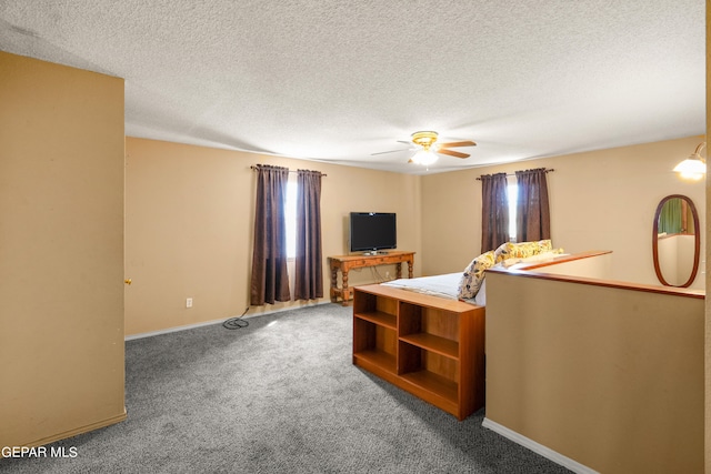 living room with ceiling fan, carpet flooring, and a textured ceiling