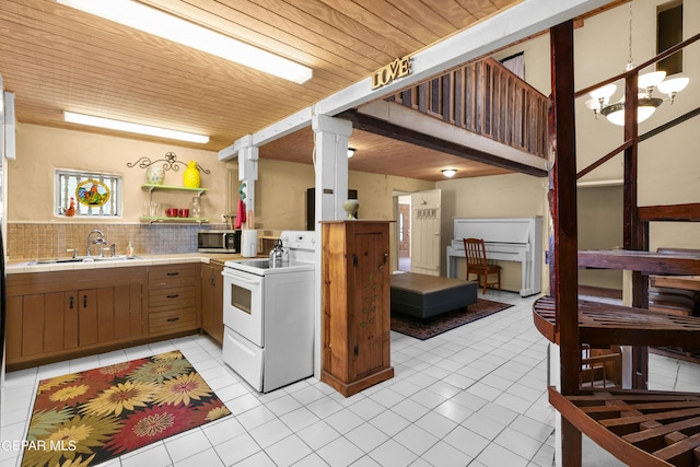 kitchen with backsplash, sink, light tile floors, and white electric range