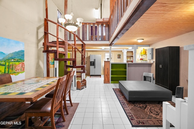 dining space featuring a notable chandelier and light tile flooring