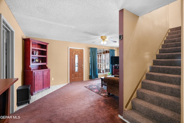 interior space featuring ceiling fan and a textured ceiling