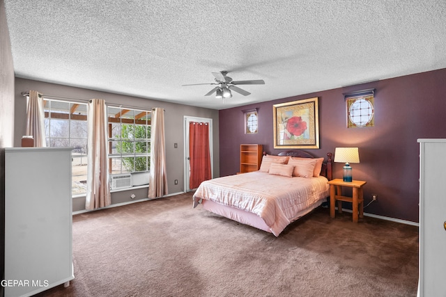 carpeted bedroom featuring ceiling fan and a textured ceiling